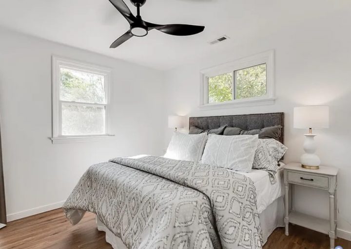 After shot of a bedroom with light grey furnishings taken from a successful Borrower rehab project funded by Marie William Capital.
